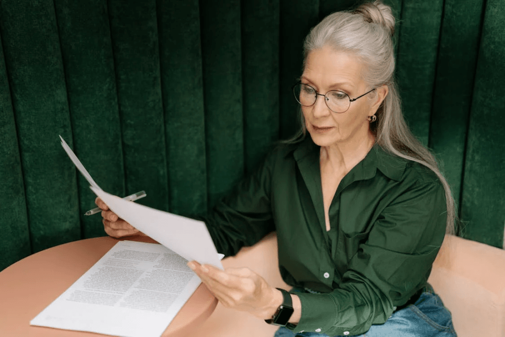 an elderly woman checking documents