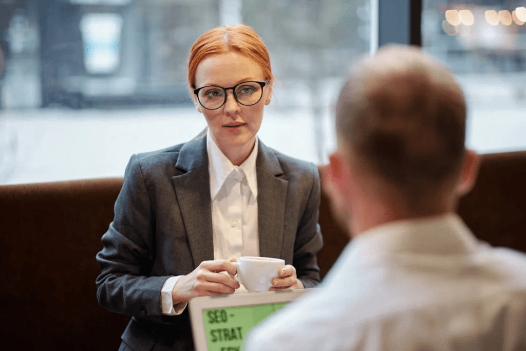 An image of a Dallas woman wearing a suit and holding a cup