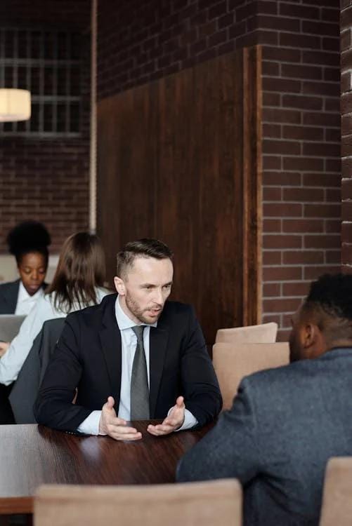 An image of two men talking in a café in Dallas