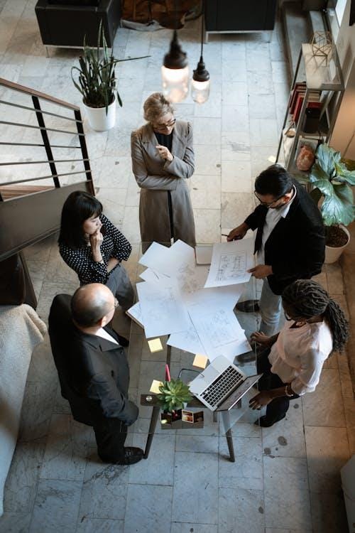 An image of people standing around a table in an office in Dallas 