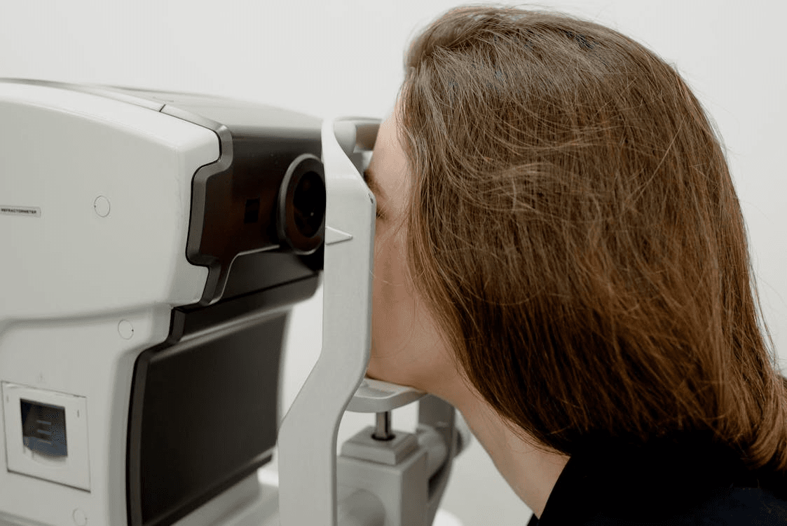 A patient getting their eyes checked using modern equipment at an optician's clinic