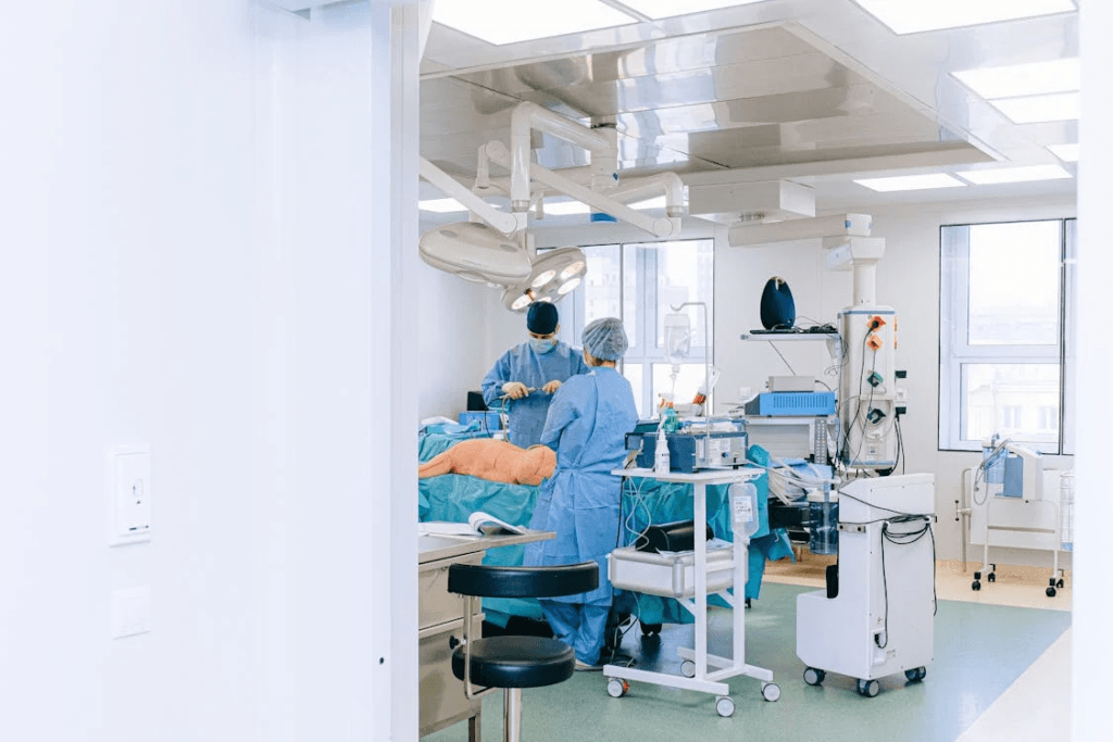 doctors and nurses inside a hospital operating room with blue clothing