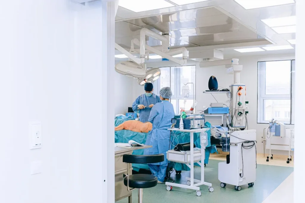 doctors and nurses inside a hospital operating room with blue clothing