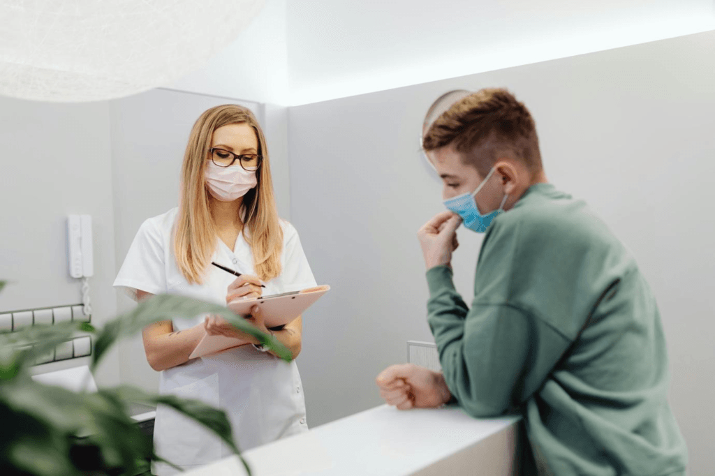 Female doctor examining a young boy patient in a medical office
