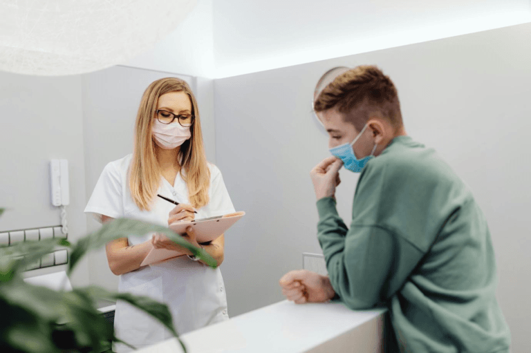 Female doctor examining a young boy patient in a medical office
