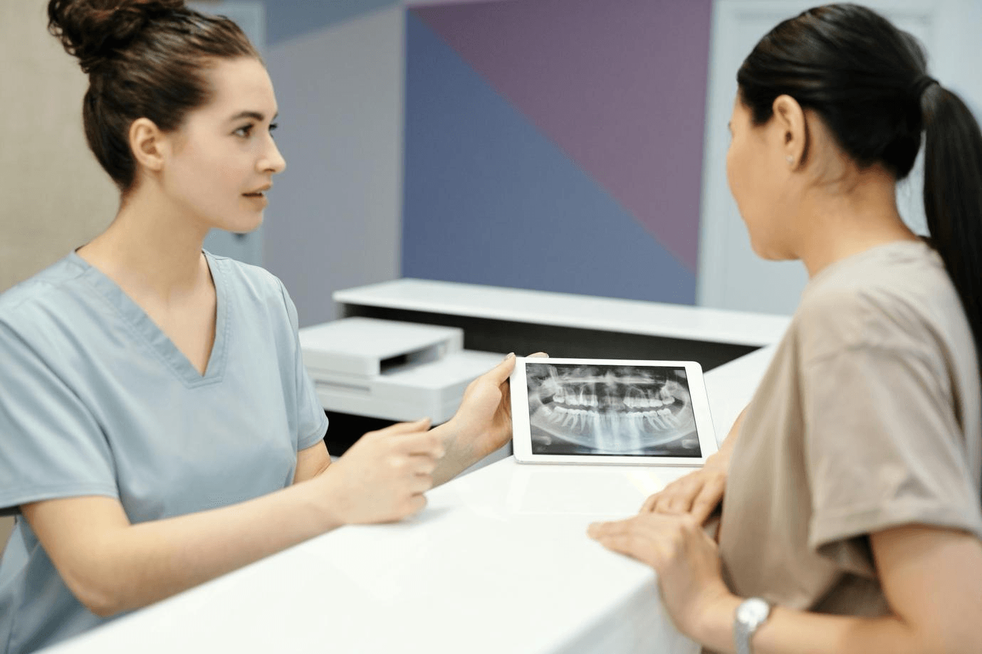  Female nurse conducting a dental scan for a female patient