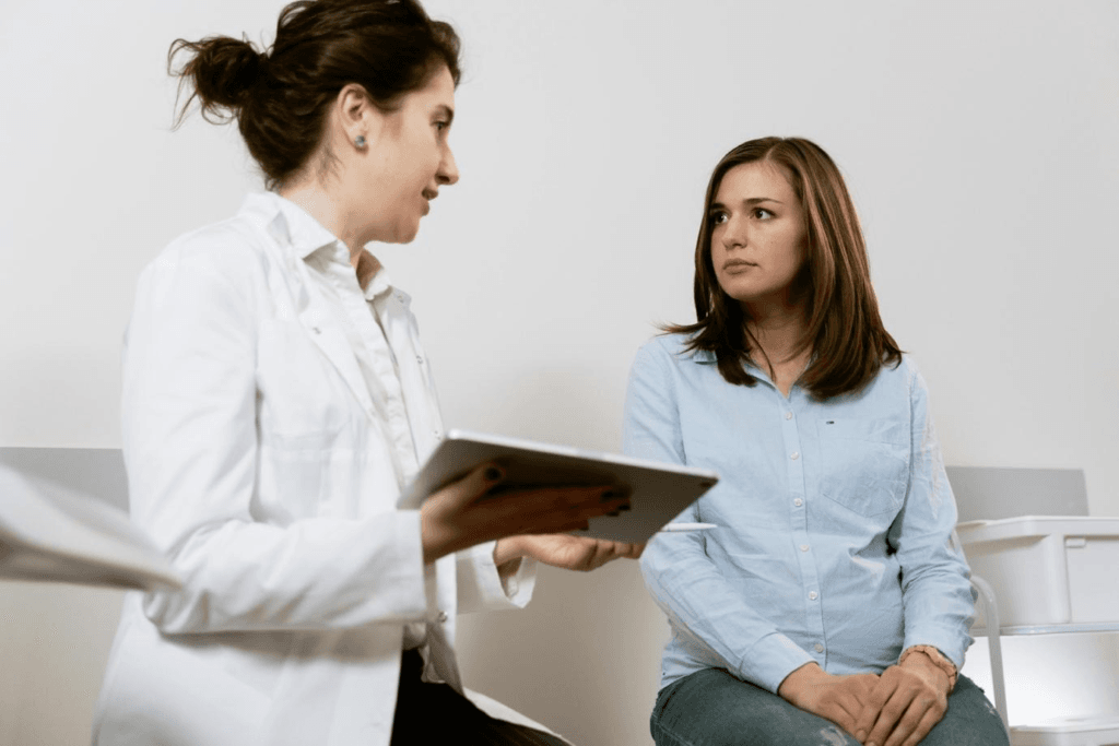 Middle-aged doctor explaining medical information to a young female patient