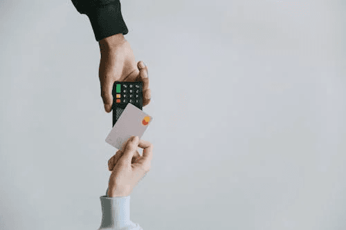 Credit score machine reading a hand reflecting the impact on life insurance approval