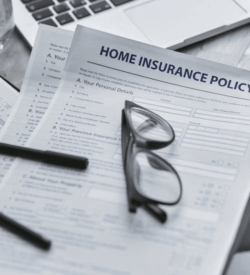 Health insurance policy papers with reading glasses on a desk in Florida