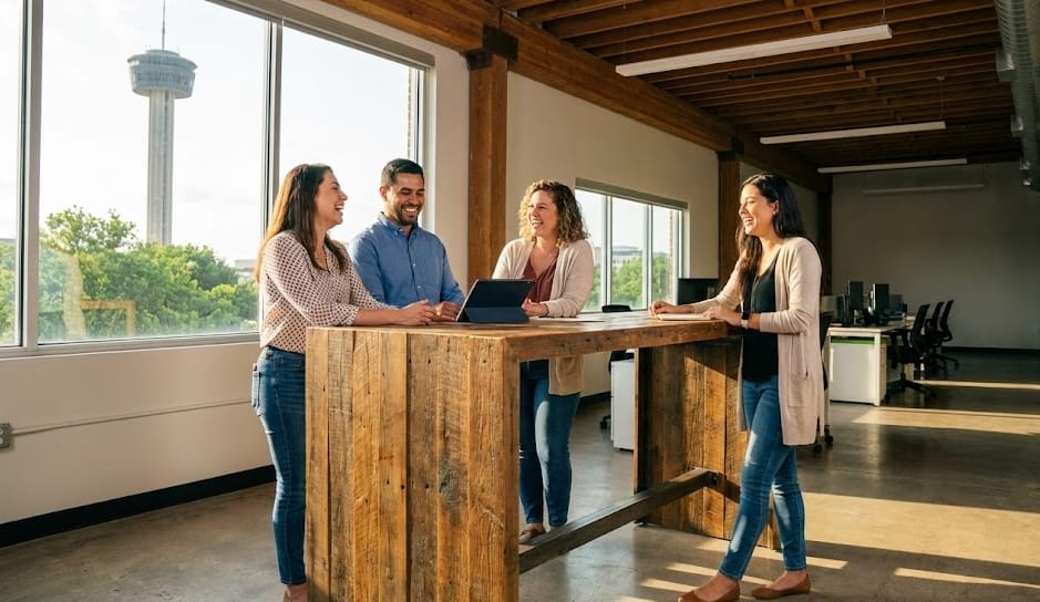Small business team in a modern Texas office discussing health benefits with a sense of optimism and wellness.