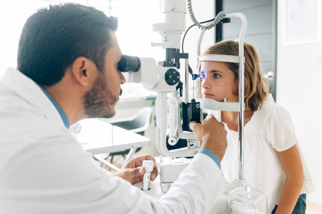 Eye doctor examining a child for Vision Insurance Plans in Texas.
